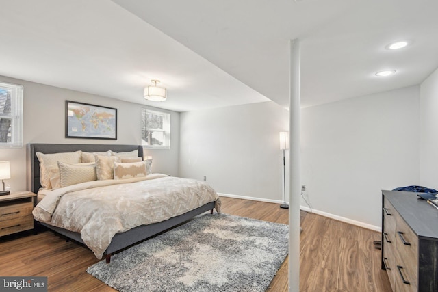 bedroom featuring baseboards and wood finished floors