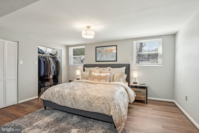 bedroom featuring baseboards and wood finished floors