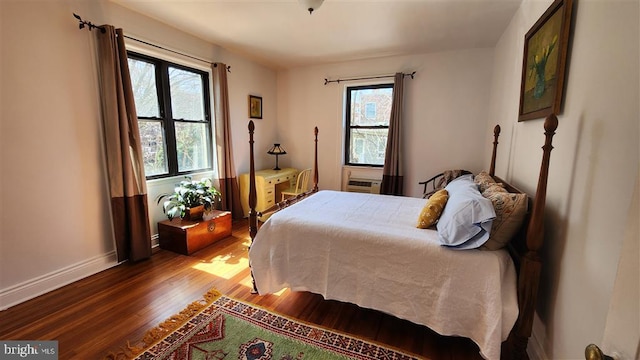 bedroom featuring baseboards and wood finished floors