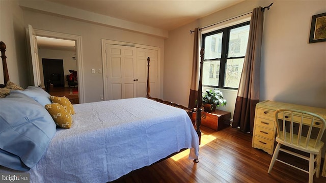 bedroom with a closet and dark wood-style floors