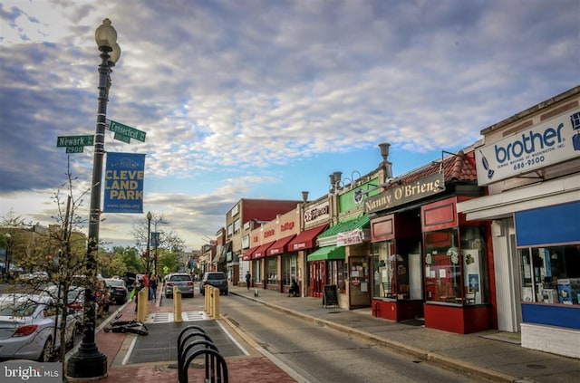 view of street featuring sidewalks, curbs, and street lights