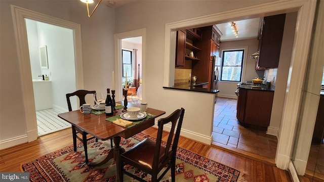 dining area featuring baseboards and wood finished floors