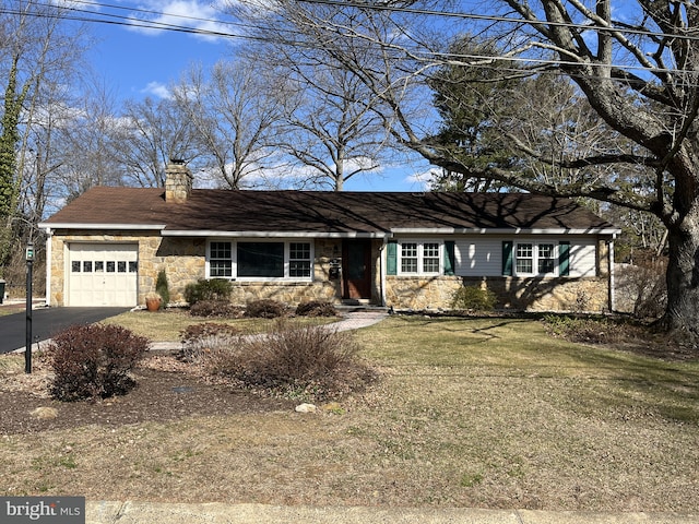 ranch-style home featuring stone siding, an attached garage, a chimney, and driveway