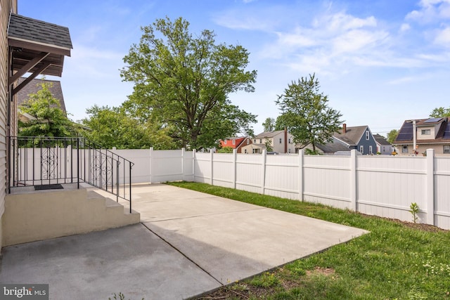 view of patio featuring a fenced backyard and a residential view