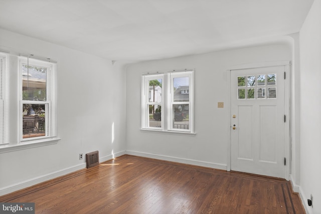 foyer entrance with wood finished floors and baseboards