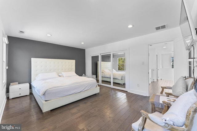 bedroom with hardwood / wood-style floors, recessed lighting, and visible vents