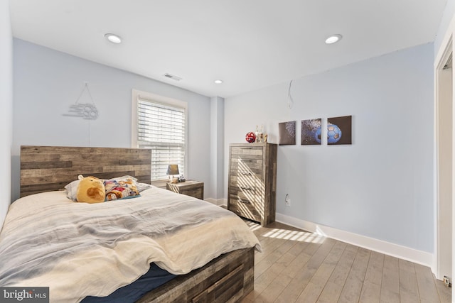 bedroom featuring recessed lighting, visible vents, wood-type flooring, and baseboards