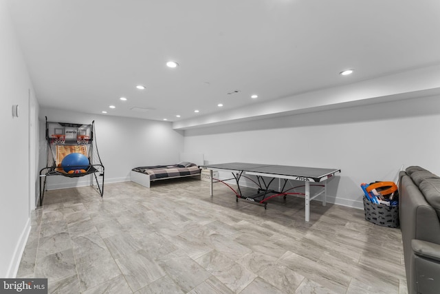 recreation room with recessed lighting and baseboards