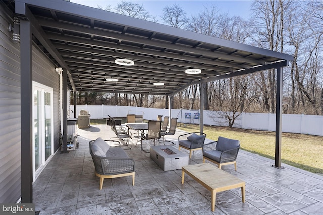 view of patio / terrace featuring an outdoor living space with a fire pit and a fenced backyard