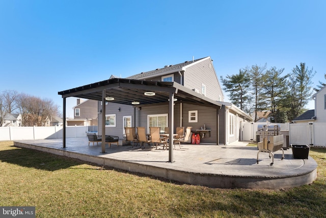 rear view of property with a patio, a lawn, and a fenced backyard