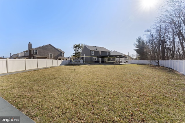 view of yard with a fenced backyard and volleyball court