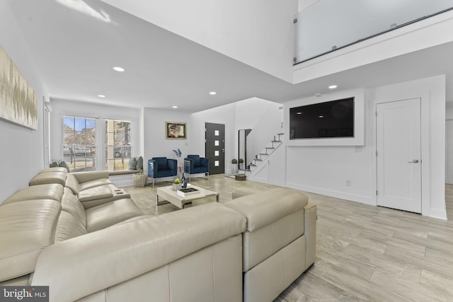 living area featuring stairway, recessed lighting, and baseboards