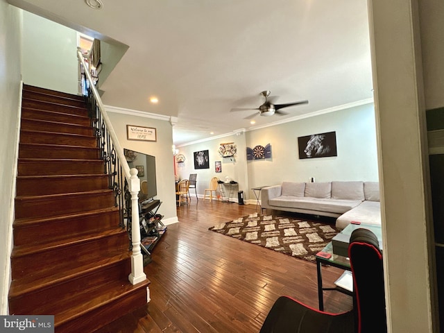 living area featuring stairway, ornamental molding, ceiling fan, and wood-type flooring