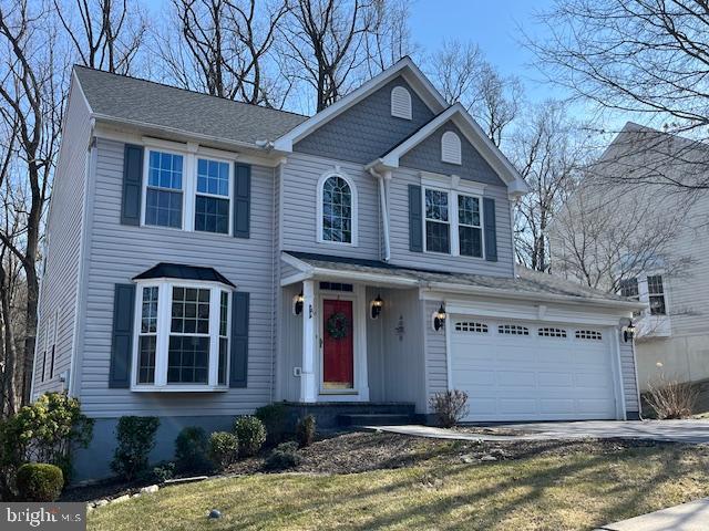 view of front of home with driveway and a garage