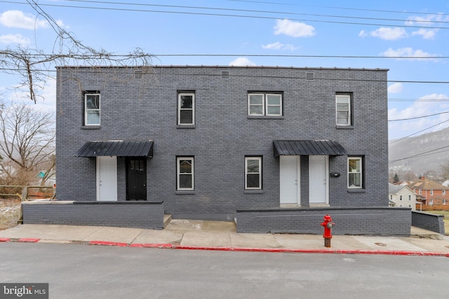 view of property featuring brick siding