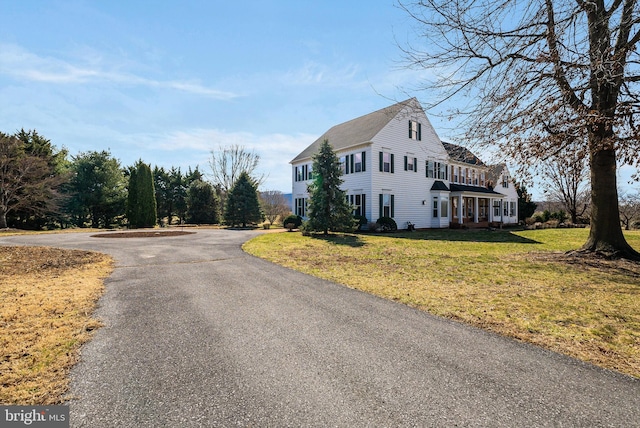 exterior space with driveway and a front yard