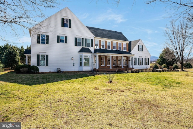 rear view of house featuring a lawn