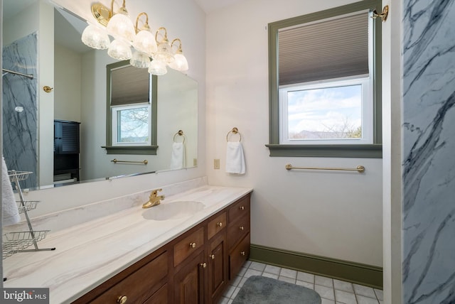 bathroom featuring tile patterned flooring, a shower, baseboards, a chandelier, and vanity