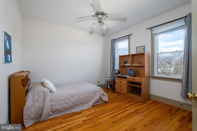 bedroom with light wood-style flooring and ceiling fan