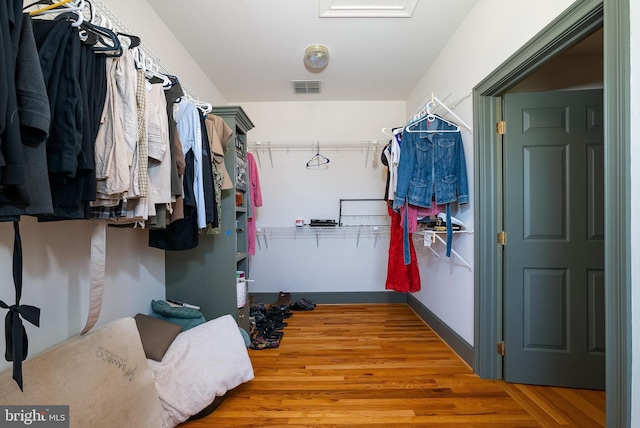 spacious closet with visible vents and wood finished floors