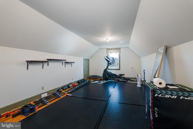 exercise area with lofted ceiling and wood finished floors