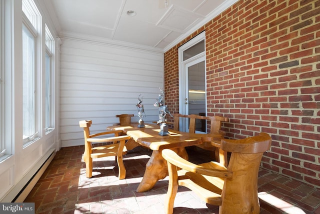 sunroom featuring a wealth of natural light and a baseboard radiator