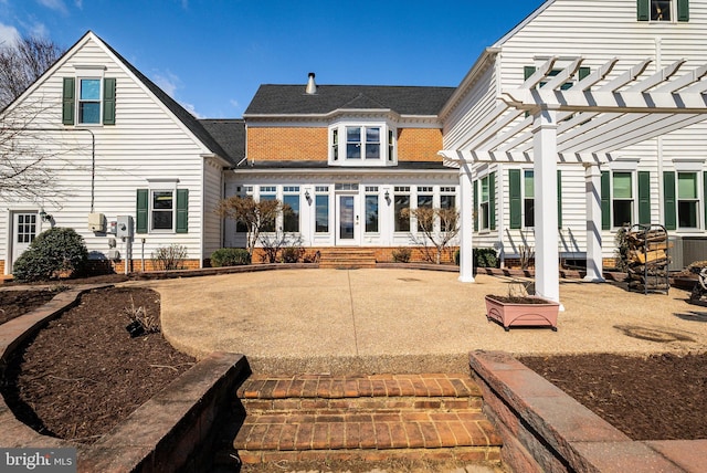 back of property featuring a pergola