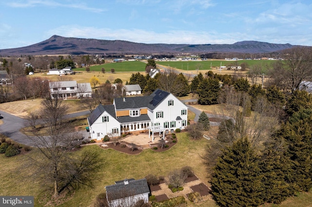 birds eye view of property featuring a mountain view