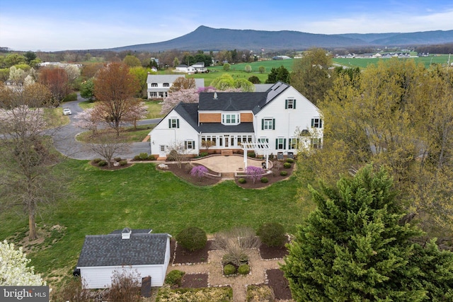 birds eye view of property featuring a mountain view