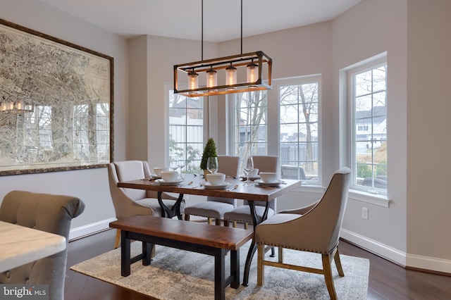 dining area with dark wood finished floors and baseboards