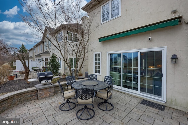 view of patio / terrace featuring cooling unit, a grill, and outdoor dining area