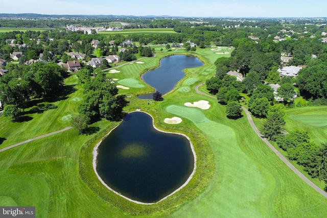 drone / aerial view featuring view of golf course and a water view