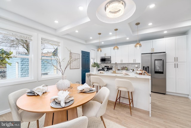 dining room featuring beam ceiling, coffered ceiling, recessed lighting, and light wood finished floors