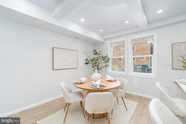 dining room with light wood finished floors, beamed ceiling, recessed lighting, and baseboards