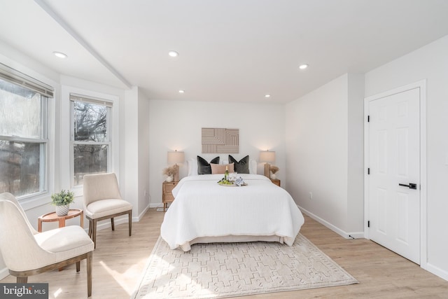 bedroom with recessed lighting, light wood-style flooring, and baseboards