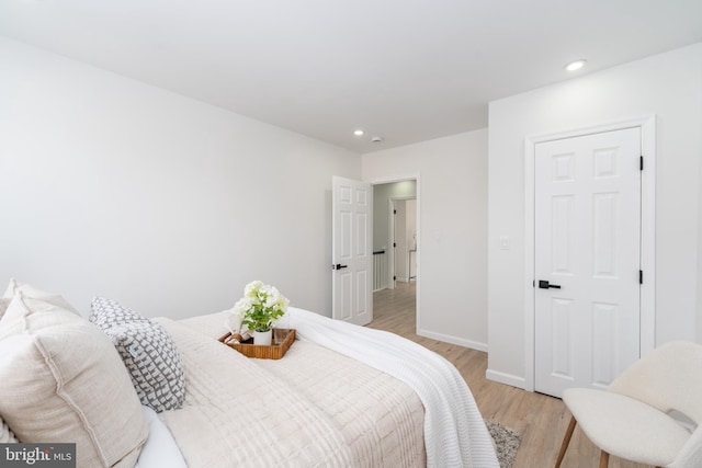 bedroom featuring recessed lighting, light wood-type flooring, and baseboards