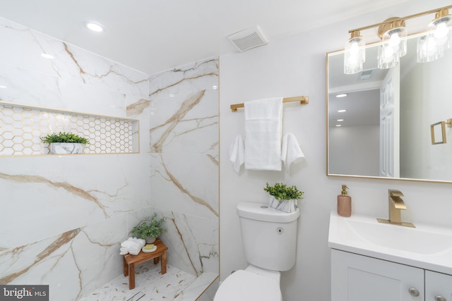 full bath featuring vanity, toilet, visible vents, and a marble finish shower