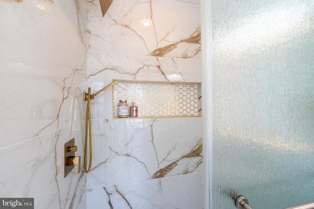 full bath featuring a marble finish shower