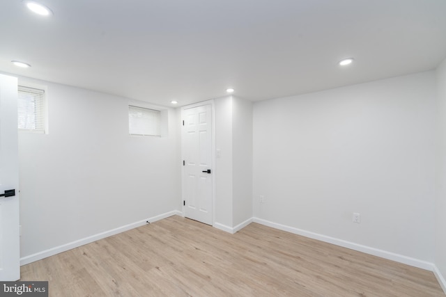 basement with recessed lighting, light wood-type flooring, and baseboards