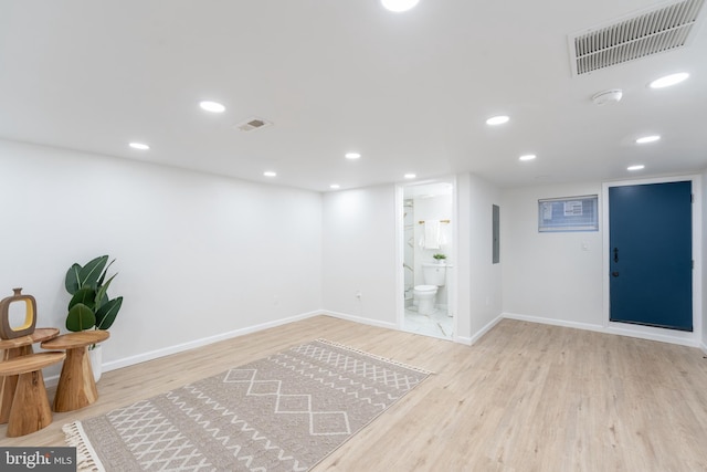 below grade area with visible vents, recessed lighting, baseboards, and wood finished floors