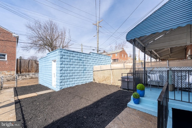 view of yard featuring a storage shed, central air condition unit, a fenced backyard, and an outdoor structure