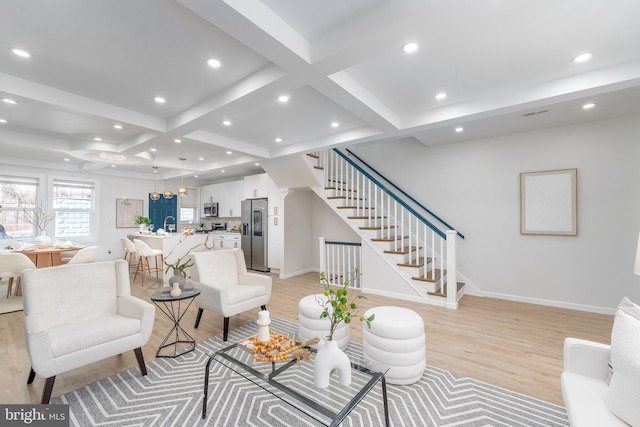 living room featuring stairs, light wood-style flooring, and recessed lighting