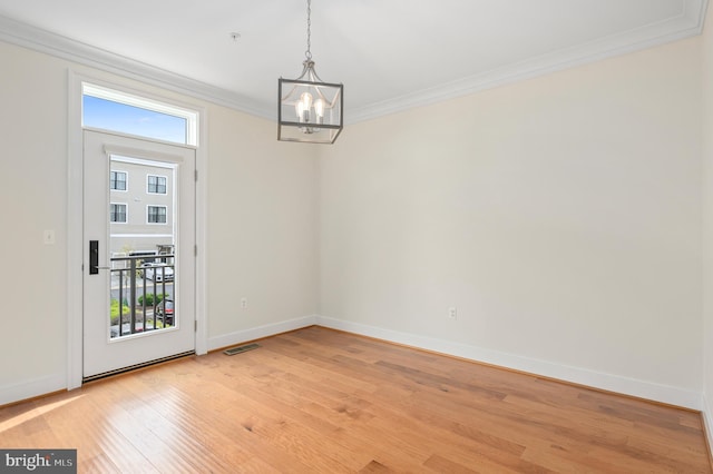 unfurnished dining area featuring visible vents, baseboards, an inviting chandelier, ornamental molding, and light wood-style floors