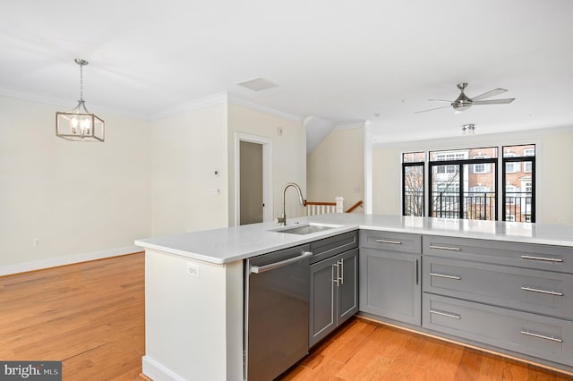 kitchen featuring gray cabinets, dishwasher, light wood-style flooring, and a sink