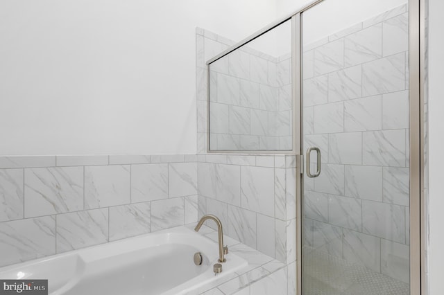 full bathroom featuring a garden tub and a stall shower