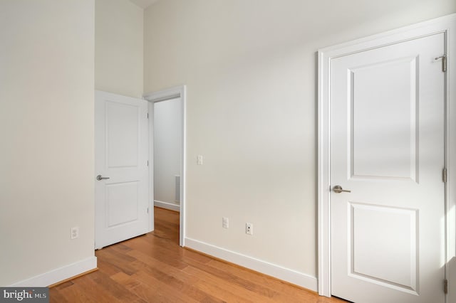 unfurnished bedroom featuring visible vents, baseboards, and light wood finished floors