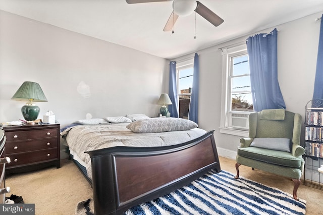 bedroom with cooling unit, baseboards, light carpet, and ceiling fan