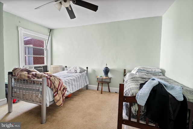 carpeted bedroom featuring cooling unit, baseboards, and ceiling fan