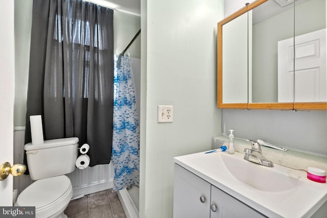 full bathroom with toilet, a stall shower, and vanity