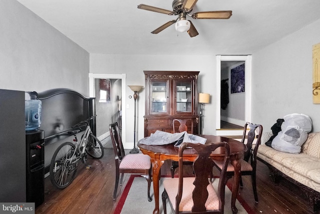 dining room featuring ceiling fan and dark wood finished floors